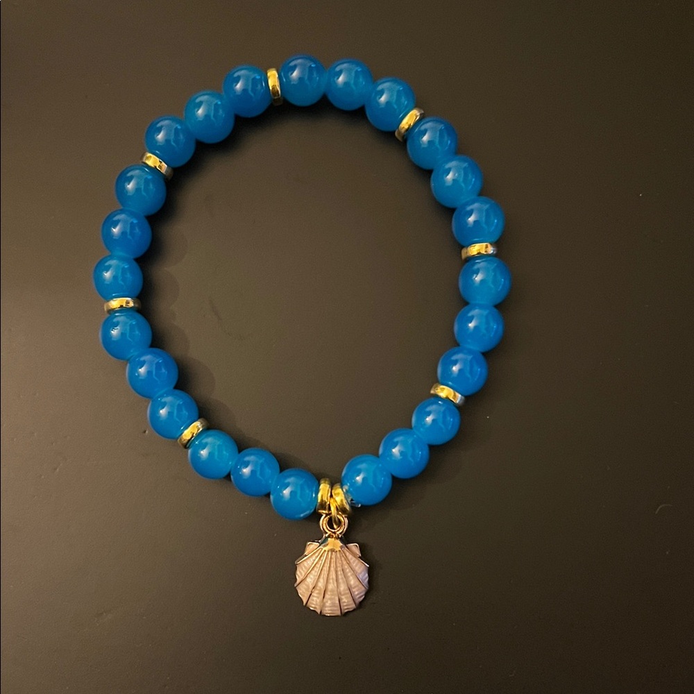 Hand Crafted Blue Bracelet with Gold Details and Shell Charm